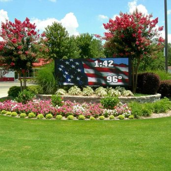 ProgresScape Landscape - an american flag sign in the middle of a flower bed - Landscape Architects or Designers Near Me ProgresScape Landscape - an american flag sign in the middle of a flower bed - Landscape Architects or Designers Near Me