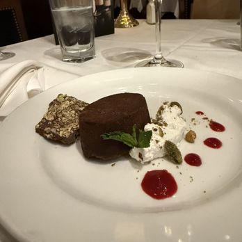 The Capital Grille - Flourless Chocolate Espresso Cake with chocolate pistachio brittle and raspberry coulis - Steakhouses Near Me - Phoenix, Arizona