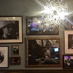 a chandelier, framed photographs, and framed photographs a chandelier, framed photographs, and framed photographs