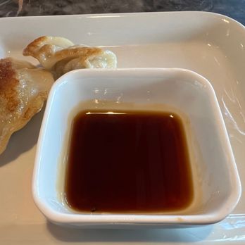Rouge - a plate of dumplings and a bowl of sauce - Asian Fusion Near Me - Brossard, Quebec Rouge - a plate of dumplings and a bowl of sauce - Asian Fusion Near Me - Brossard, Quebec