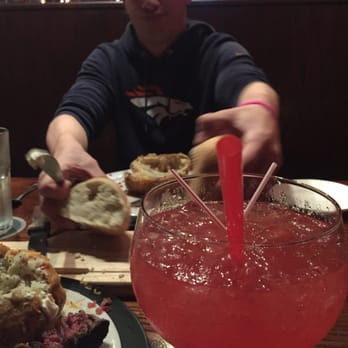 Ruby River Steakhouse - Well strawberry margarita and the boyfriend enjoying the bread. - Steakhouses Near Me - Reno, Nevada