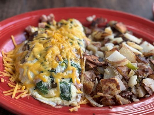 Photo of Jake's Roadhouse - Monrovia, CA, US. Build your own omelette. This one had mushroom, cheddar cheese, ham, spinach. Served with Potatoes.