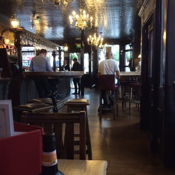 The York - Bright interior considering the black ceiling - Pubs Near Me - London, XGL