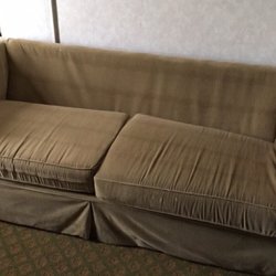 A Victory Inn & Suites - Couch that's been drug from the alley and put in room...equipped with stains and missing back cushions