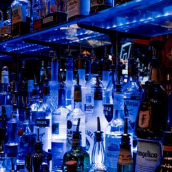 Paymon's Lounge and Hookah Bar - Backlit liquor bottles displayed behind the full bar at Paymon's Lounge in Las Vegas.