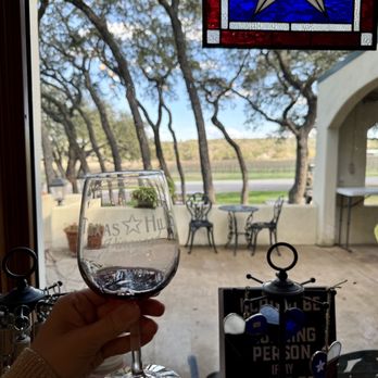 Napa Collection - a hand holding a glass of wine - Wineries Near Me - Johnson City, Texas