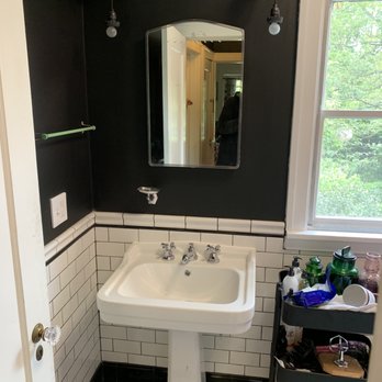 Dairy Factory - a white pedestal sink in a black and white bathroom - General Contractors Near Me Dairy Factory - a white pedestal sink in a black and white bathroom - General Contractors Near Me