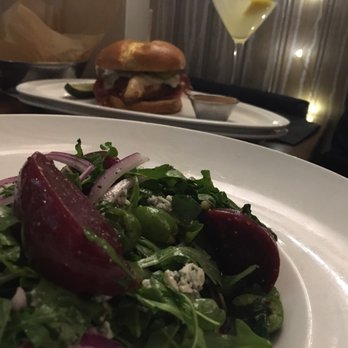 Central Kitchen + Bar - Pickled beets salad and behind, the Buttermilk fried chicken sandwich - Gastropubs Near Me - Detroit, Michigan