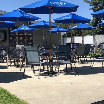 The Last Resort - tables and chairs with blue umbrellas - Bars Near Me - Smithfield, Rhode Island