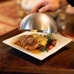 Henderson Castle - Duck a l orange; classic French dish featuring roasted duck with a sweet tangy orange sauce.  Fine dining, romantic atmosphere Kalamazoo.