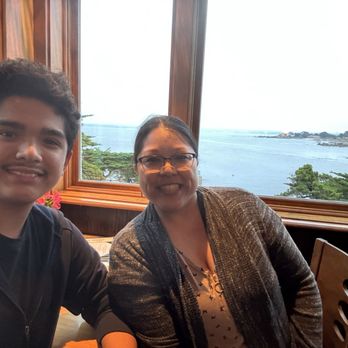 Lover's Point Beach Cafe - Posing at our corner table with the view of Monterey Bay and Lovers Point. - Cafes Near Me - Pacific Grove, California