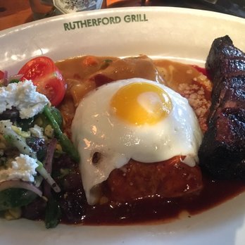 Rutherford Grill - Tri-tip and butternut squash enchilada with cucumber salad, with an added sunny side egg on top of the enchilada - American Near Me - Rutherford, California