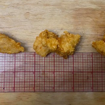 Carl's Jr. - three pieces of fried chicken on a cutting board - Fast Food Near Me - Mesa, Arizona