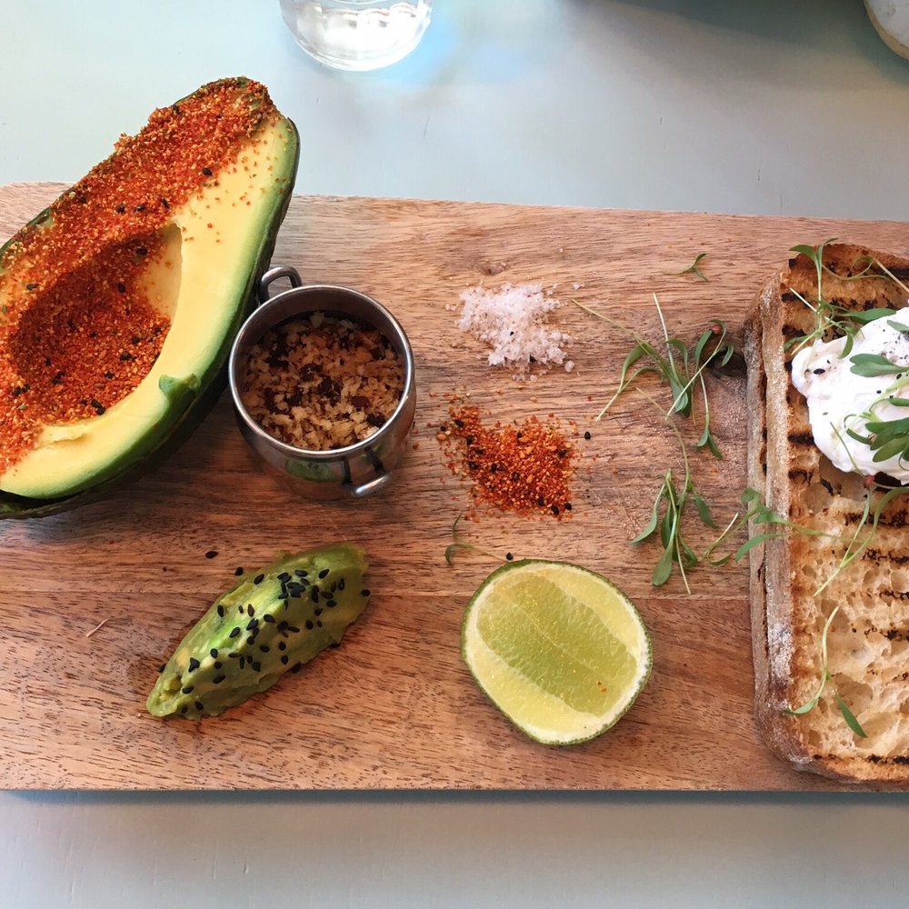 Spicy smashed avocado with the addition of a poached egg and bacon crumb.