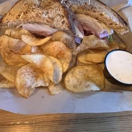 Double decker club with house chips and ranch dressing. Double decker club with house chips and ranch dressing.