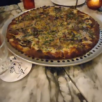 Danny’s Pizza Tavern - a pizza on a table - Pizza Near Me - Toronto, Ontario