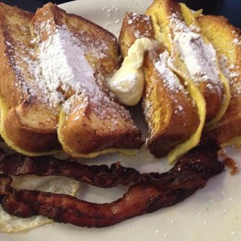 The Red Hut Cafe - An egg over easy is hiding under French toast and 2 pieces of crispy bacon - American Near Me - Carson City, Nevada The Red Hut Cafe - An egg over easy is hiding under French toast and 2 pieces of crispy bacon - American Near Me - Carson City, Nevada