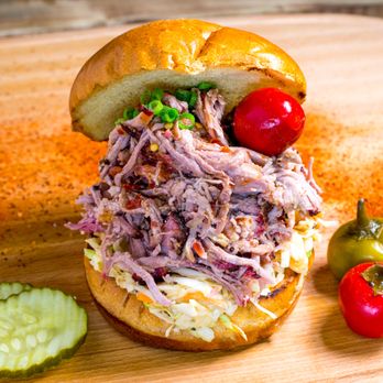 Rollin Smoke BBQ - Big Hawg Sandwich - Pulled pork stacked high with slaw & BBQ sauce on a toasted bun. Juicy, messy, and delicious. - Barbeque Near Me - Avondale, Arizona Rollin Smoke BBQ - Big Hawg Sandwich - Pulled pork stacked high with slaw & BBQ sauce on a toasted bun. Juicy, messy, and delicious. - Barbeque Near Me - Avondale, Arizona
