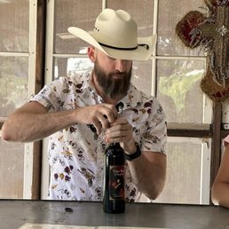 a man pouring wine into a bottle