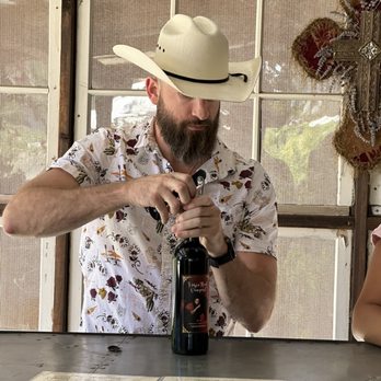 Horse Thief Vineyard - a man pouring wine into a bottle - Wine Tasting Room Near Me - Morgan Hill, California