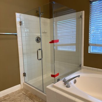 Gilbert Glass - Frameless. Red tape to hold while it is set - Glass & Mirrors Near Me