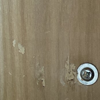 Darling Construction - a hole in a wood door - General Contractors Near Me