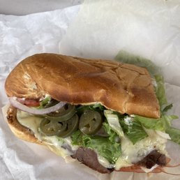 a sub sandwich with lettuce, tomato, and cheese a sub sandwich with lettuce, tomato, and cheese