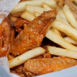 Medium sauced wings and French Fries in their signature white to go box. Medium sauced wings and French Fries in their signature white to go box.