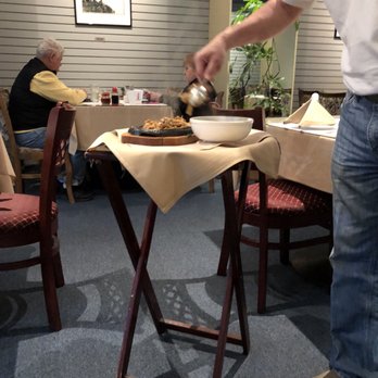China Village - a man pouring tea over a plate of food - Chinese Near Me - Novato, California China Village - a man pouring tea over a plate of food - Chinese Near Me - Novato, California
