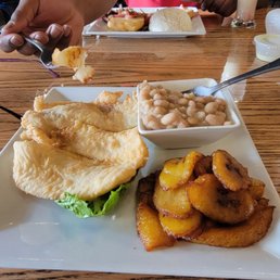 Filet of fish , canary beans, and platano Maduro. My son had steak potato onions tomato and white rice