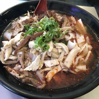 King Noodle - Flat rice noodle in hot and spicy broth with pork intestine and free range chicken - Noodles Near Me - Seattle, Washington