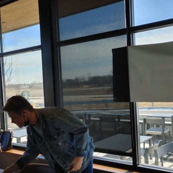 Starbucks - a man and a little girl sitting at a table - Coffee & Tea Near Me - Loves Park, Illinois