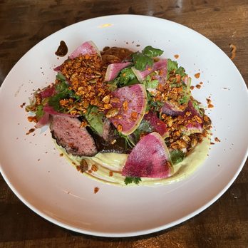 Nobie's - Ribeyes Without a Face - tomatillo salsa, avocado crema, pepita crunch, hominy & masa cake - New American Near Me - Houston, Texas Nobie's - Ribeyes Without a Face - tomatillo salsa, avocado crema, pepita crunch, hominy & masa cake - New American Near Me - Houston, Texas