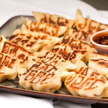 Baoz Dumpling - a plate of dumplings with dipping sauce - Chinese Near Me - Houston, Texas