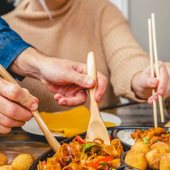 Pei Wei Asian Kitchen - a woman eating a meal with chopsticks - Asian Fusion Near Me - Fairfax, Virginia Pei Wei Asian Kitchen - a woman eating a meal with chopsticks - Asian Fusion Near Me - Fairfax, Virginia