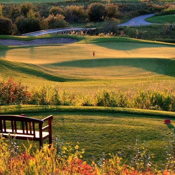 Sirocco Golf Club - a wooden bench overlooking a golf course - Golf Near Me - Foothills, Alberta Sirocco Golf Club - a wooden bench overlooking a golf course - Golf Near Me - Foothills, Alberta