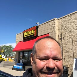 a man in front of a restaurant a man in front of a restaurant