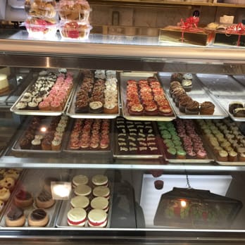 Lassen & Hennigs - Cupcakes with different icings along with tarts on the bottom shelf. - Delis Near Me - Brooklyn, New York Lassen & Hennigs - Cupcakes with different icings along with tarts on the bottom shelf. - Delis Near Me - Brooklyn, New York