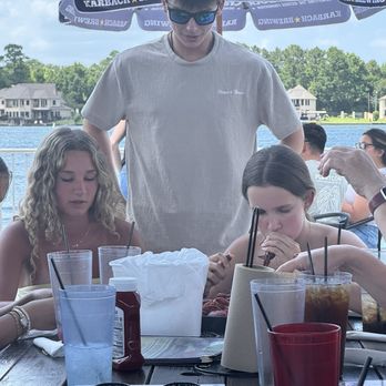 Conroe Lake House - Ella showing her cousin from Minnesota how to eat crawfish! - American Near Me - Montgomery, Texas Conroe Lake House - Ella showing her cousin from Minnesota how to eat crawfish! - American Near Me - Montgomery, Texas