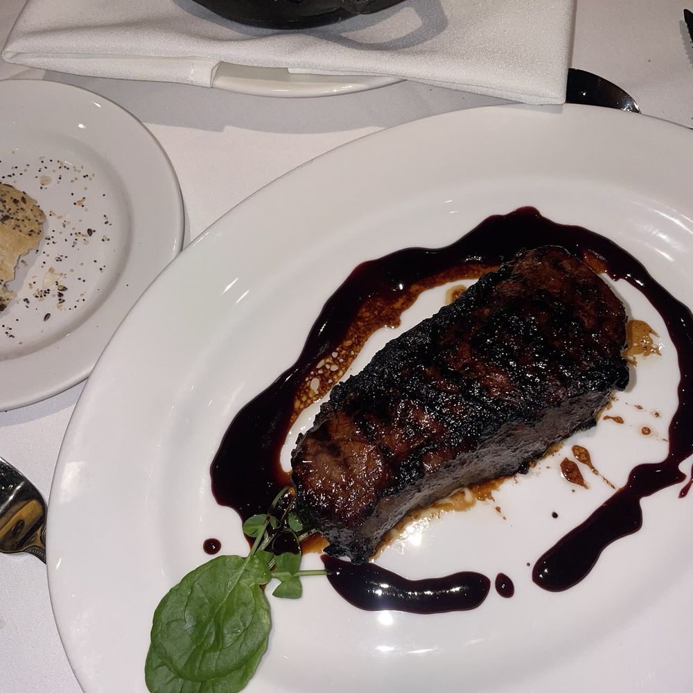 The Capital Grille - Dry Aged Bone-In NY/KC Strip with a black glaze - Steakhouses Near Me - Burbank, California The Capital Grille - Dry Aged Bone-In NY/KC Strip with a black glaze - Steakhouses Near Me - Burbank, California