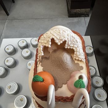 Tica Designer Cakes - Baby Shower cake sweet earth tones w orange (FL), peach (GA) & covered baby in carriage. - Cupcakes Near Me - North Miami, Florida