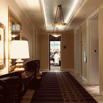 Kimpton Hotel Monaco Seattle - Elevator lobby with mirror, chairs and traditional cove lighting.   When was the last time one set in a chair in elevator lobby? - Hotels Near Me - Seattle, Washington