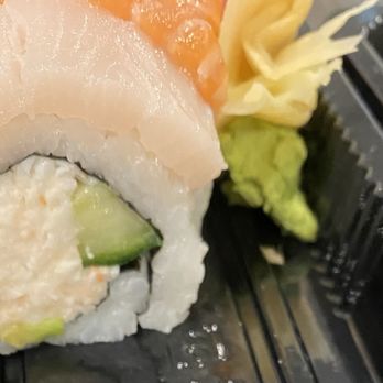 Sushi Time - Rainbow roll with a sliver of avocado. - Japanese Near Me - Torrance, California Sushi Time - Rainbow roll with a sliver of avocado. - Japanese Near Me - Torrance, California