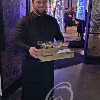 Ovation Event Staffing - Team Member Josh serving up the signature drink with a smile at a Gala in March. - Caterers Near Me - Houston, Texas Ovation Event Staffing - Team Member Josh serving up the signature drink with a smile at a Gala in March. - Caterers Near Me - Houston, Texas