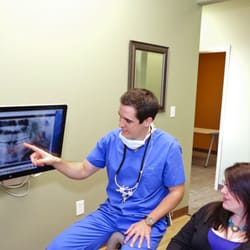 Comal Dental - Dr. Earnest helping consulting a patient.