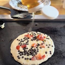 Pancake with chocolate chips and strawberries