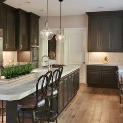 Olivenhain Design - Two words: Pure elegance. Deeply rich, espresso cabinets married with Taj Mahal Quartzite and transitional pendants to add depth. 2020