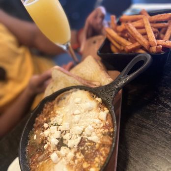 Charlies Bar & Kitchen - Shakshuka- onions, mushrooms, peppers, red sauce, with poached eggs and toast - Cocktail Bars Near Me - Bronx, New York Charlies Bar & Kitchen - Shakshuka- onions, mushrooms, peppers, red sauce, with poached eggs and toast - Cocktail Bars Near Me - Bronx, New York
