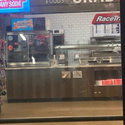 Attendant behind the counter on his phone