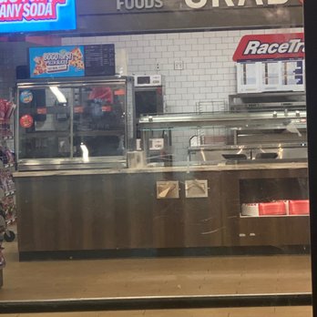 RaceTrac - Attendant behind the counter on his phone - Gas Stations Near Me - McDonough, Georgia